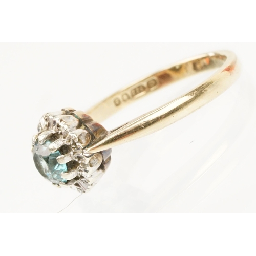 50 - 9ct gold zircon and diamond halo ring. The ring being set with a round cut zircon to the centre surr... 