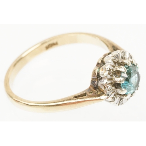 50 - 9ct gold zircon and diamond halo ring. The ring being set with a round cut zircon to the centre surr... 