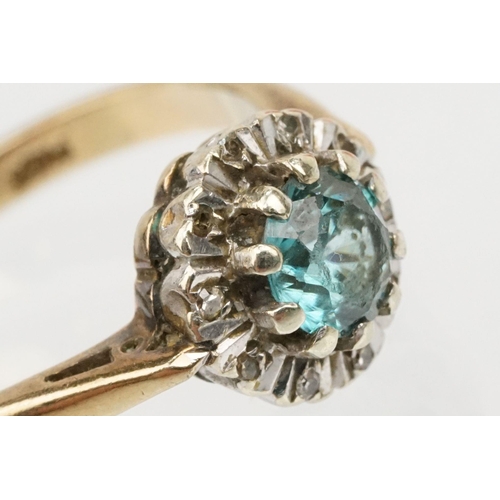 50 - 9ct gold zircon and diamond halo ring. The ring being set with a round cut zircon to the centre surr... 