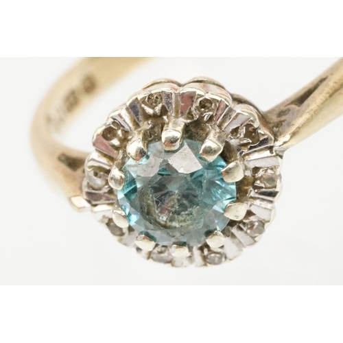 50 - 9ct gold zircon and diamond halo ring. The ring being set with a round cut zircon to the centre surr... 