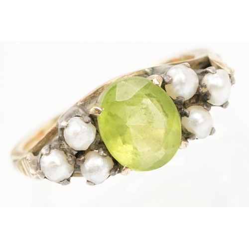 52 - Peridot and pearl dress ring. The ring being set with an oval cut peridot to centre flanked by six s... 