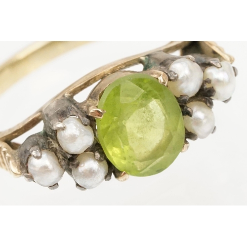 52 - Peridot and pearl dress ring. The ring being set with an oval cut peridot to centre flanked by six s... 