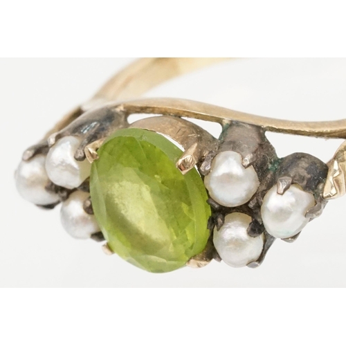 52 - Peridot and pearl dress ring. The ring being set with an oval cut peridot to centre flanked by six s... 