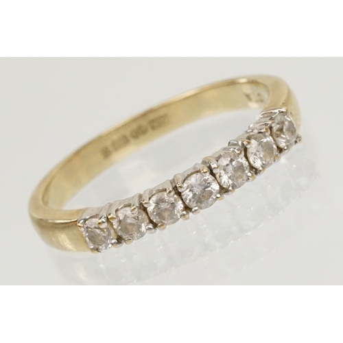 63 - 9ct gold and diamond seven stone ring. The ring being prong set with seven round brilliant cut diamo... 