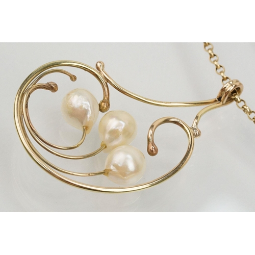 65 - 9ct gold and cultured pearl pendant necklace having a large scrolled pendant set with three pearls m... 