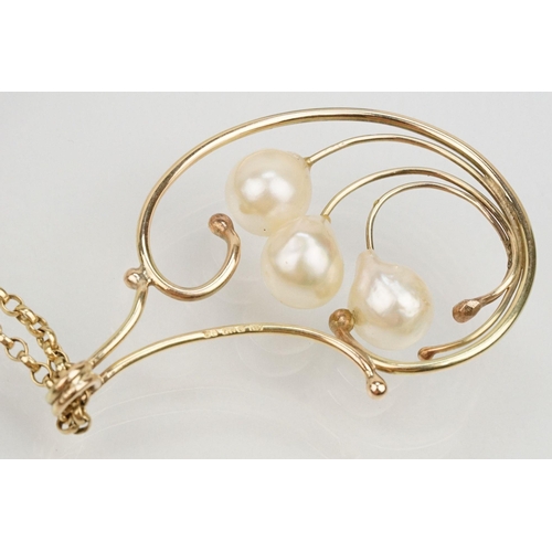 65 - 9ct gold and cultured pearl pendant necklace having a large scrolled pendant set with three pearls m... 