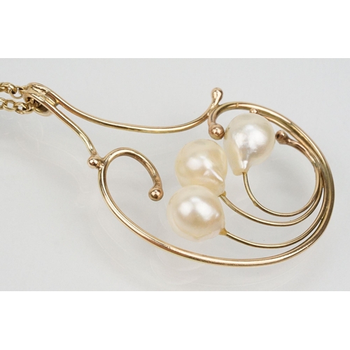 65 - 9ct gold and cultured pearl pendant necklace having a large scrolled pendant set with three pearls m... 