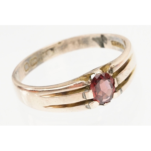 67 - Victorian 9ct gold and garnet ring. The ring being set with an oval cut garnet with reeded shoulders... 