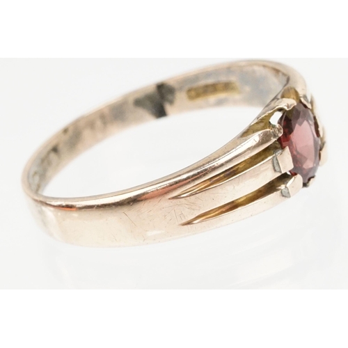 67 - Victorian 9ct gold and garnet ring. The ring being set with an oval cut garnet with reeded shoulders... 