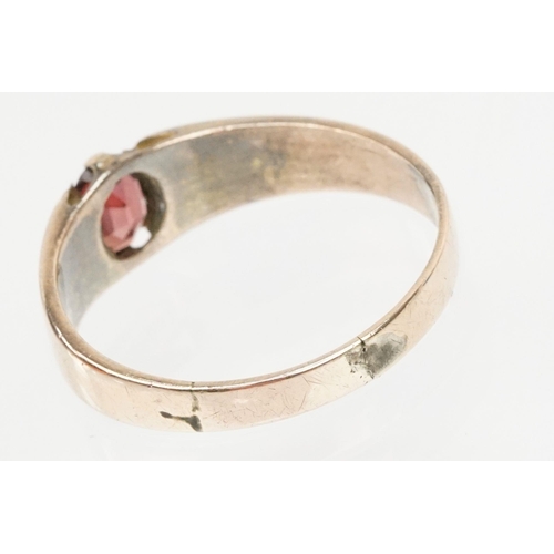 67 - Victorian 9ct gold and garnet ring. The ring being set with an oval cut garnet with reeded shoulders... 