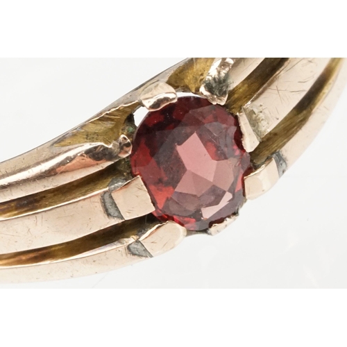 67 - Victorian 9ct gold and garnet ring. The ring being set with an oval cut garnet with reeded shoulders... 