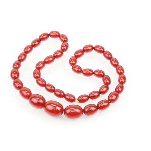 69 - 1930s bakelite necklace strung with graduating oval cherry bakelite beads. Largest ad measures 2.8cm... 