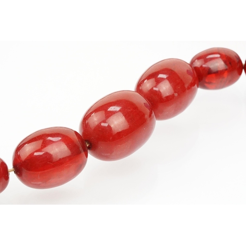 69 - 1930s bakelite necklace strung with graduating oval cherry bakelite beads. Largest ad measures 2.8cm... 