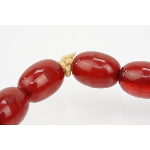 69 - 1930s bakelite necklace strung with graduating oval cherry bakelite beads. Largest ad measures 2.8cm... 