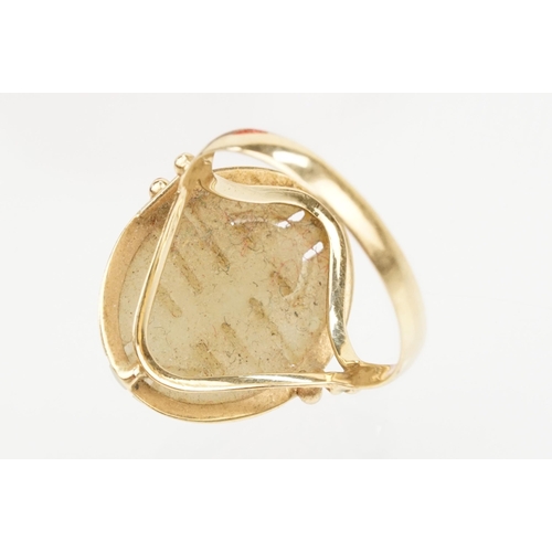 73 - 18ct gold and jade ring. The ring being set with an oval carved jade panel with pierced detailing. M... 