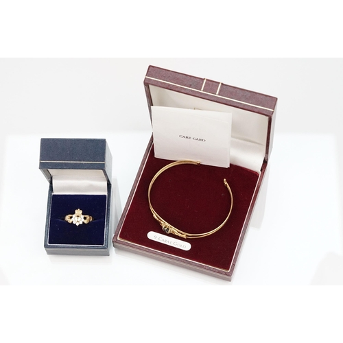 74 - 9ct gold Claddagh bangle bracelet being set with a heart cut blue stone to centre with cz accent sto... 