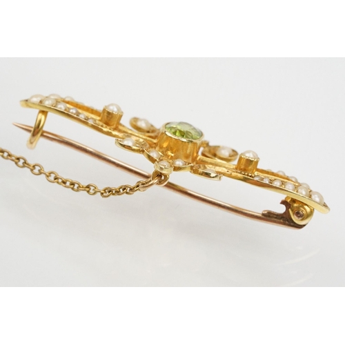 75 - Edwardian 15ct gold, peridot and a seedpearl brooch having an oval cut peridot to the centre with ha... 