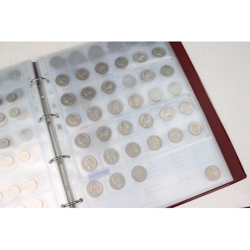 135 - A very large collection of mixed World coins in alphabetical order within six collectors albums.