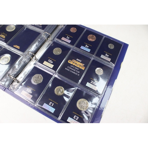 235 - A collection of Queen Elizabeth II and King Charles III brilliant uncirculated coins within a change... 