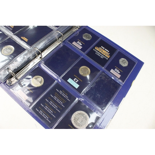 235 - A collection of Queen Elizabeth II and King Charles III brilliant uncirculated coins within a change... 