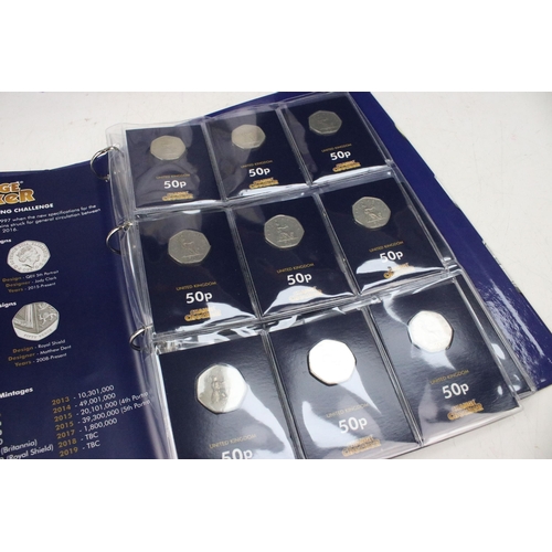 242 - A large collection of Royal Mint United Kingdom 50p collectors coins contained within two change che... 