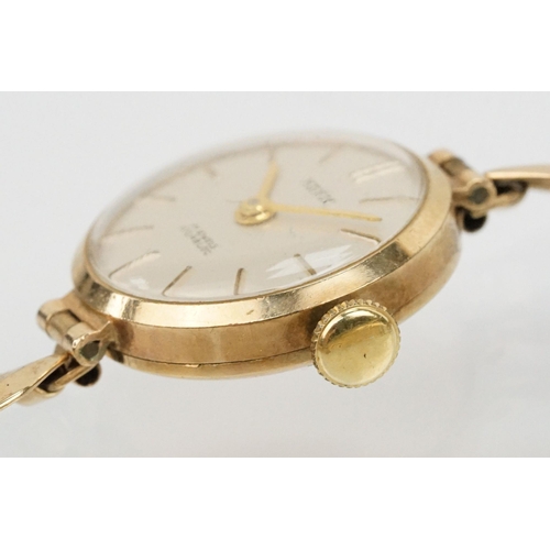 143 - 9ct gold Hefik wrist watch having a round face with baton markers to the chapter ring with panelled ... 