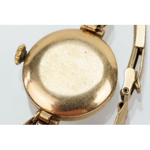 143 - 9ct gold Hefik wrist watch having a round face with baton markers to the chapter ring with panelled ... 