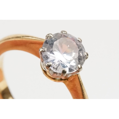 168 - White sapphire solitaire ring being set with a round brilliant cut sapphire in a prong setting on a ... 