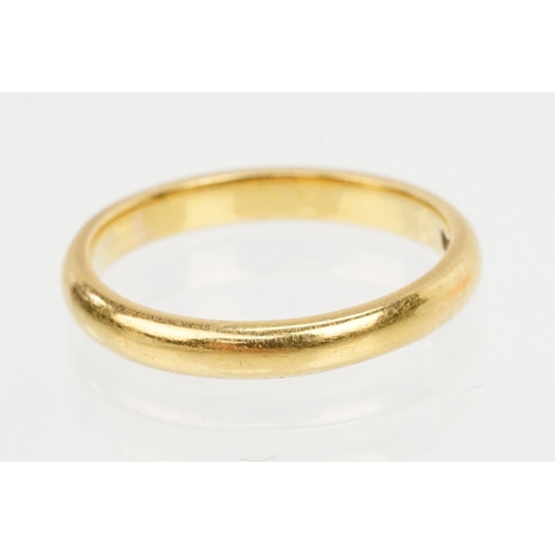 169 - 22ct gold wedding band ring. The ring of plain form. Hallmarked London 1954. Size O.