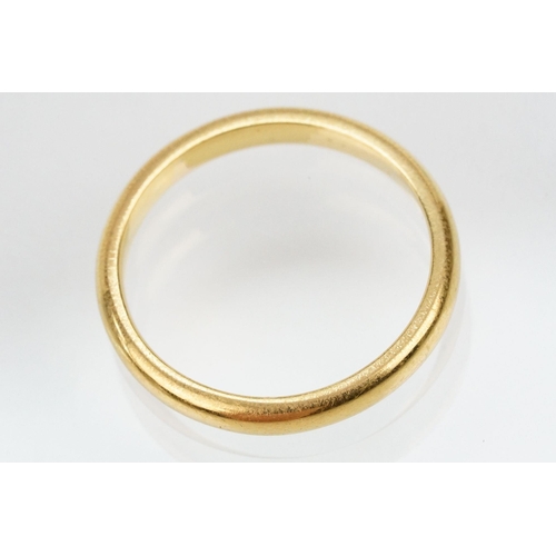 169 - 22ct gold wedding band ring. The ring of plain form. Hallmarked London 1954. Size O.