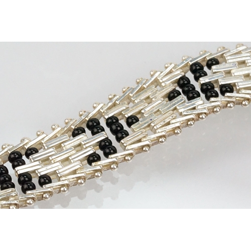 202 - Silver and black onyx bead necklace and bracelet suite. The necklace constructed from herringbone li... 