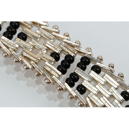 202 - Silver and black onyx bead necklace and bracelet suite. The necklace constructed from herringbone li... 