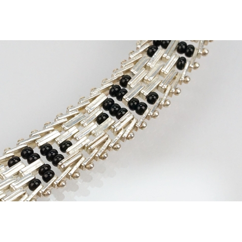 202 - Silver and black onyx bead necklace and bracelet suite. The necklace constructed from herringbone li... 