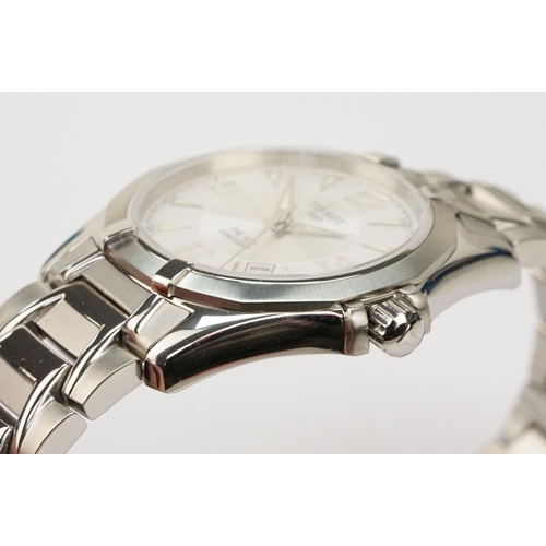 280 - Tissot PR 100 stainless steel wrist watch. The watch having a round face with white dial with arabic... 