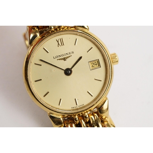 284 - Longines ladies wristwatch having a round gilt face with baton markers to the chapter ring and date ... 