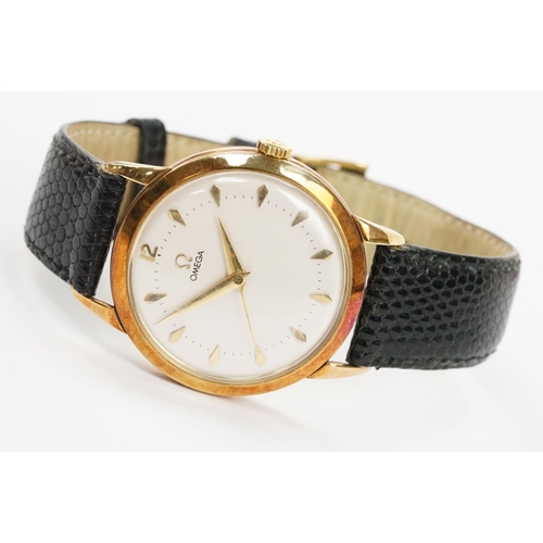 303 - Omega 14ct gold cased wrist watch having a round face with diamond shaped hour markers set to a blac... 