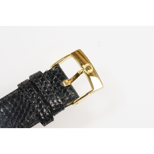 303 - Omega 14ct gold cased wrist watch having a round face with diamond shaped hour markers set to a blac... 