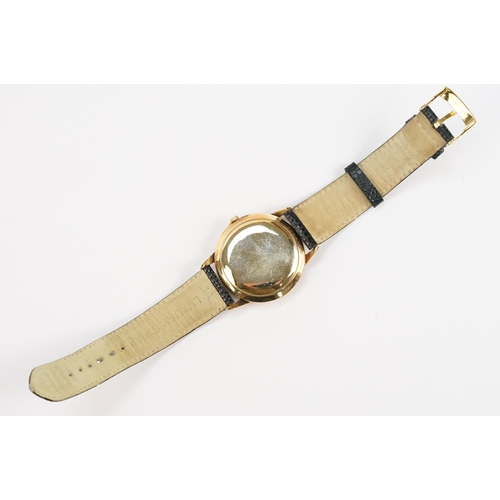 303 - Omega 14ct gold cased wrist watch having a round face with diamond shaped hour markers set to a blac... 