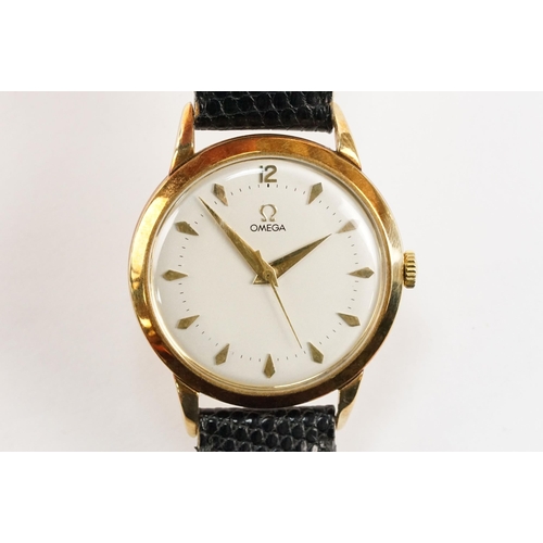 303 - Omega 14ct gold cased wrist watch having a round face with diamond shaped hour markers set to a blac... 