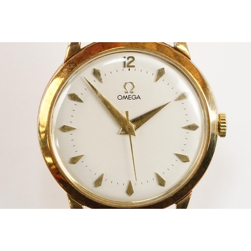 303 - Omega 14ct gold cased wrist watch having a round face with diamond shaped hour markers set to a blac... 