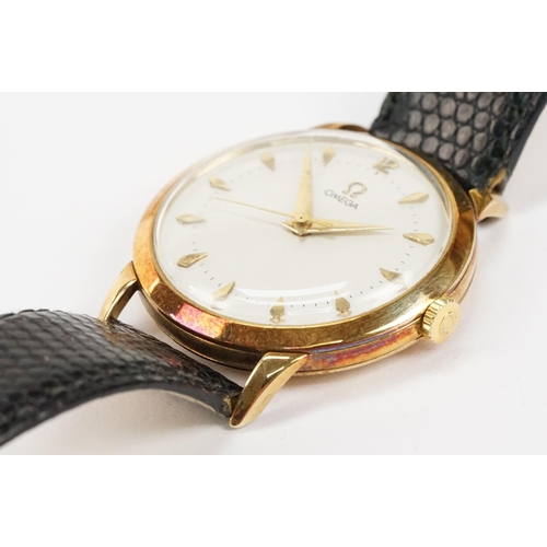 303 - Omega 14ct gold cased wrist watch having a round face with diamond shaped hour markers set to a blac... 