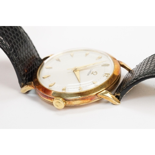 303 - Omega 14ct gold cased wrist watch having a round face with diamond shaped hour markers set to a blac... 