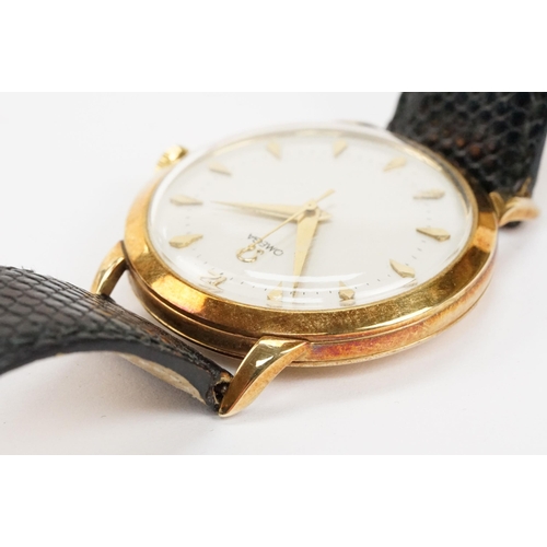 303 - Omega 14ct gold cased wrist watch having a round face with diamond shaped hour markers set to a blac... 