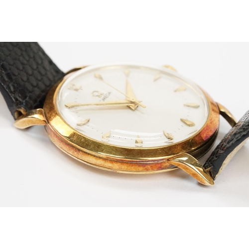 303 - Omega 14ct gold cased wrist watch having a round face with diamond shaped hour markers set to a blac... 