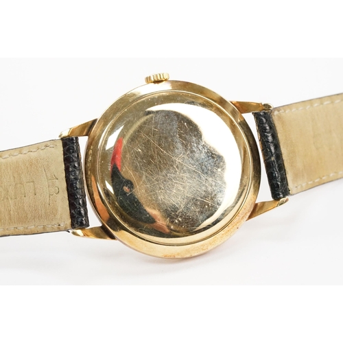 303 - Omega 14ct gold cased wrist watch having a round face with diamond shaped hour markers set to a blac... 