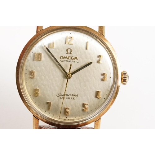 306 - Omega Seamaster De Ville automatic 9ct gold case wristwatch. The watch having a silvered dial with a... 