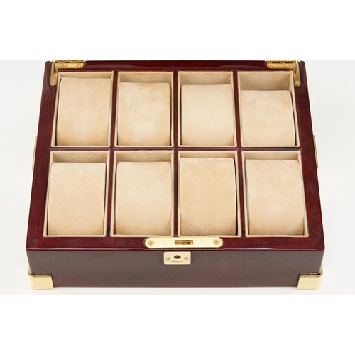 312 - Rapport of London wooden watch box with eight velvet lined compartments.