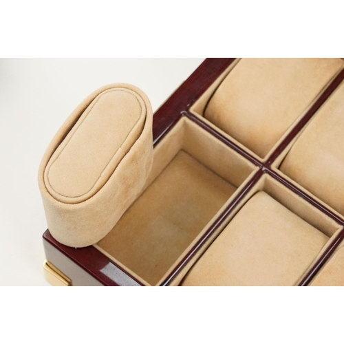 312 - Rapport of London wooden watch box with eight velvet lined compartments.