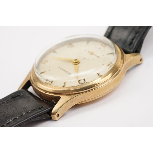 315 - Garrard 9ct gold mid Century wrist watch having a cream dial with arabic and baton markers to the ch... 