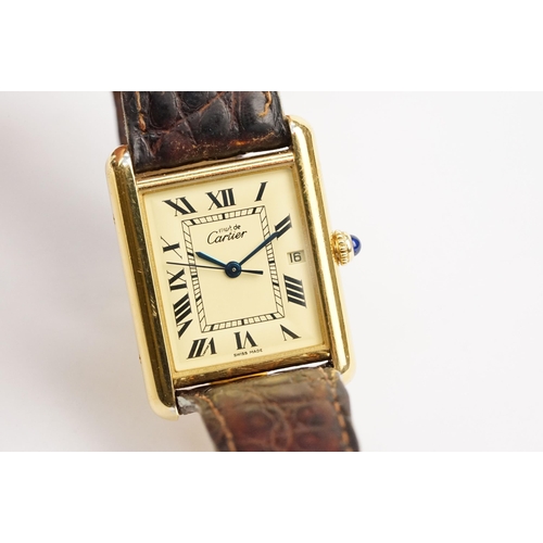 318 - Must de Cartier silver cased tank watch having a rectangular face with roman numerals to the chapter... 